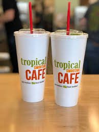 Two cups with the word tropical cafe on them.
